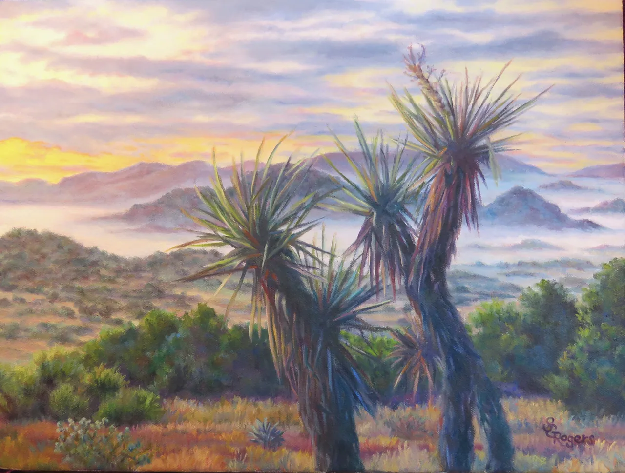 Painting of tall yuccas in the foreground with the Davis Mountains in morning mist under a pink and gold dawn sky.