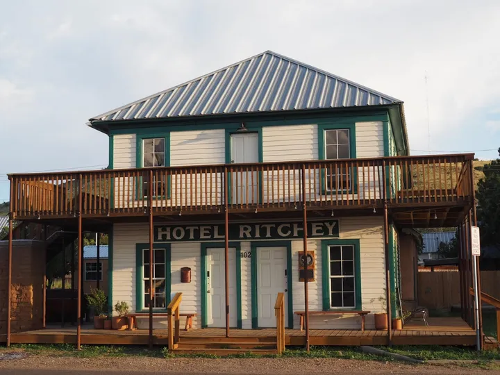 The two-story Ritchey building with its wraparound balcony and Hotel Ritchey sign.